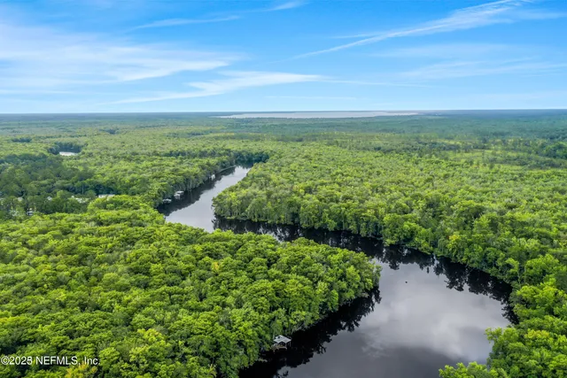 a roof deck with table and chairs and potted plants