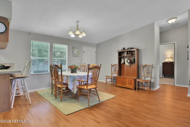 a living room with furniture a wooden floor and a flat screen tv