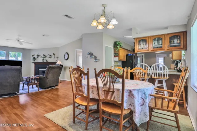 a kitchen with stainless steel appliances granite countertop a refrigerator a stove and a sink with cabinets