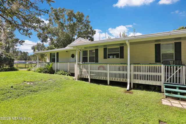 a house with green field in front of it