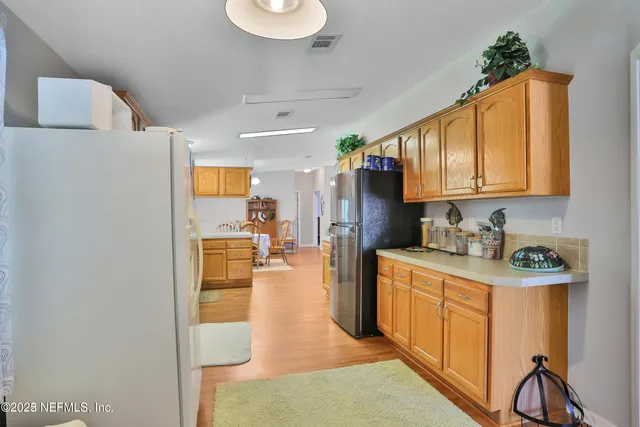a close view of a sink a faucet and a cabinet in a kitchen
