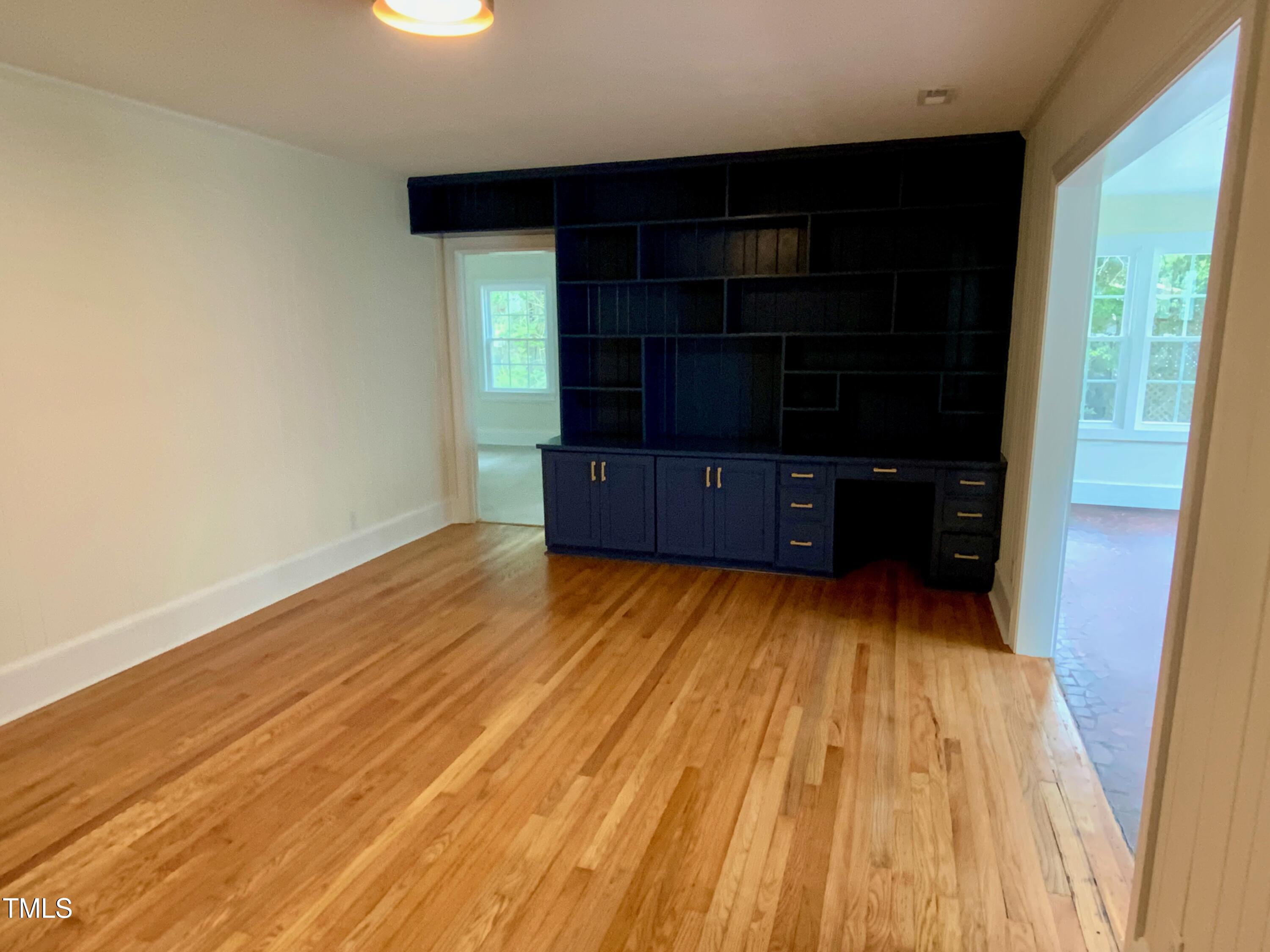 1101 West Divine Street Dunn, NC 28334 - Photo 13 of 36 a view of room with wooden floor and furniture