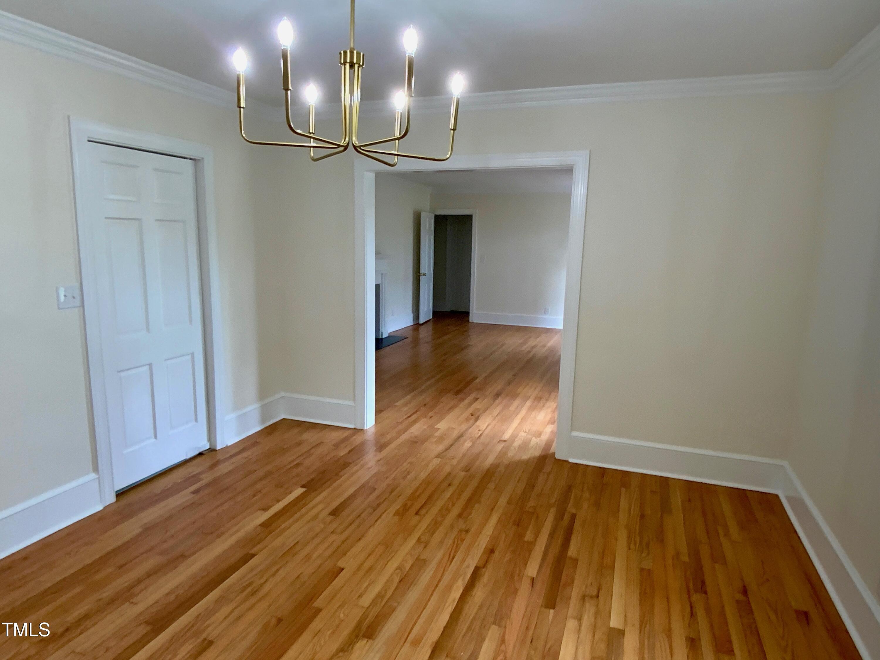 1101 West Divine Street Dunn, NC 28334 - Photo 18 of 36 a view of empty room with wooden floor