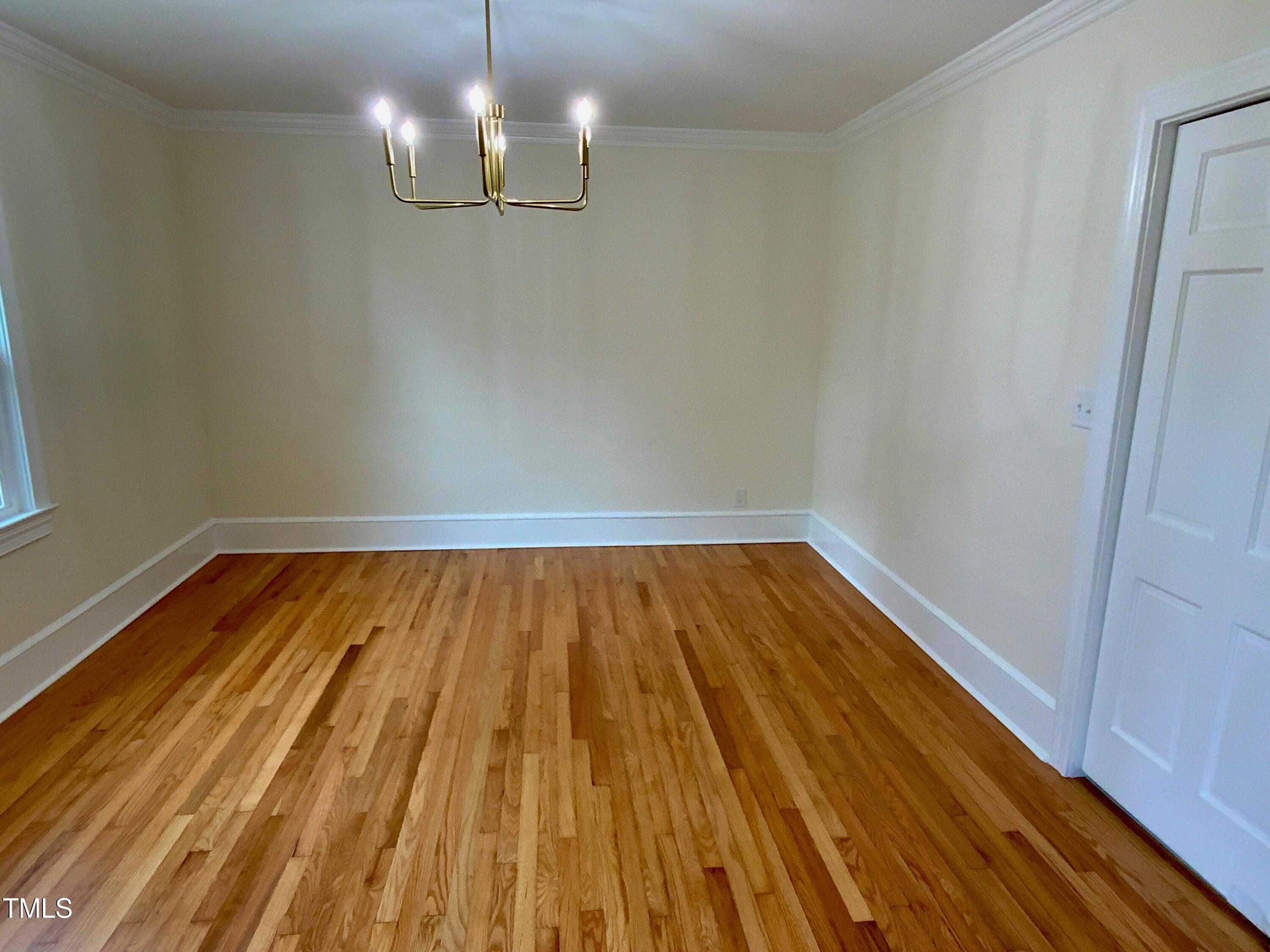 1101 West Divine Street Dunn, NC 28334 - Photo 19 of 36 a view of room with wooden floor and chandelier