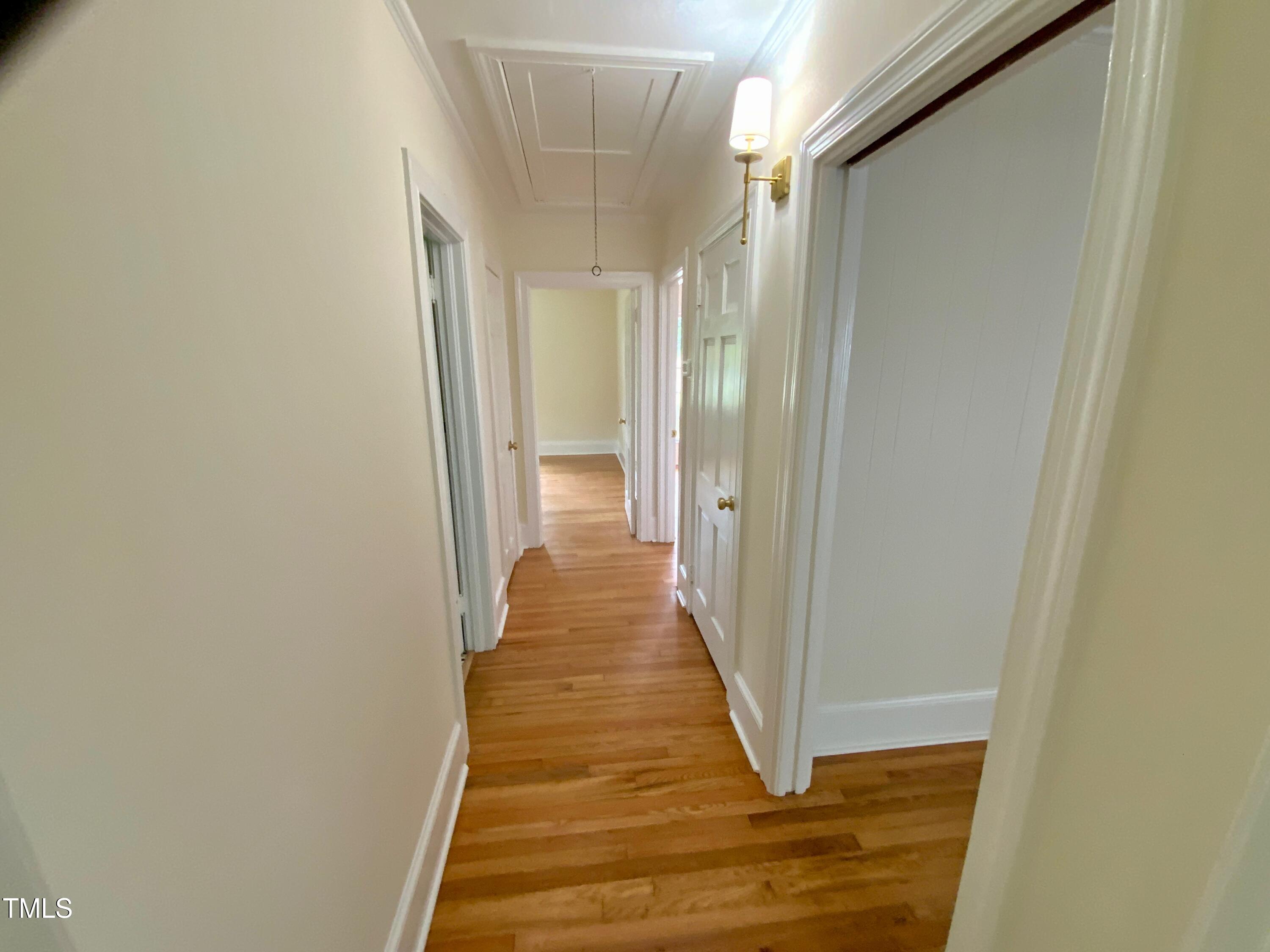 1101 West Divine Street Dunn, NC 28334 - Photo 21 of 36 a view of a hallway with wooden floor