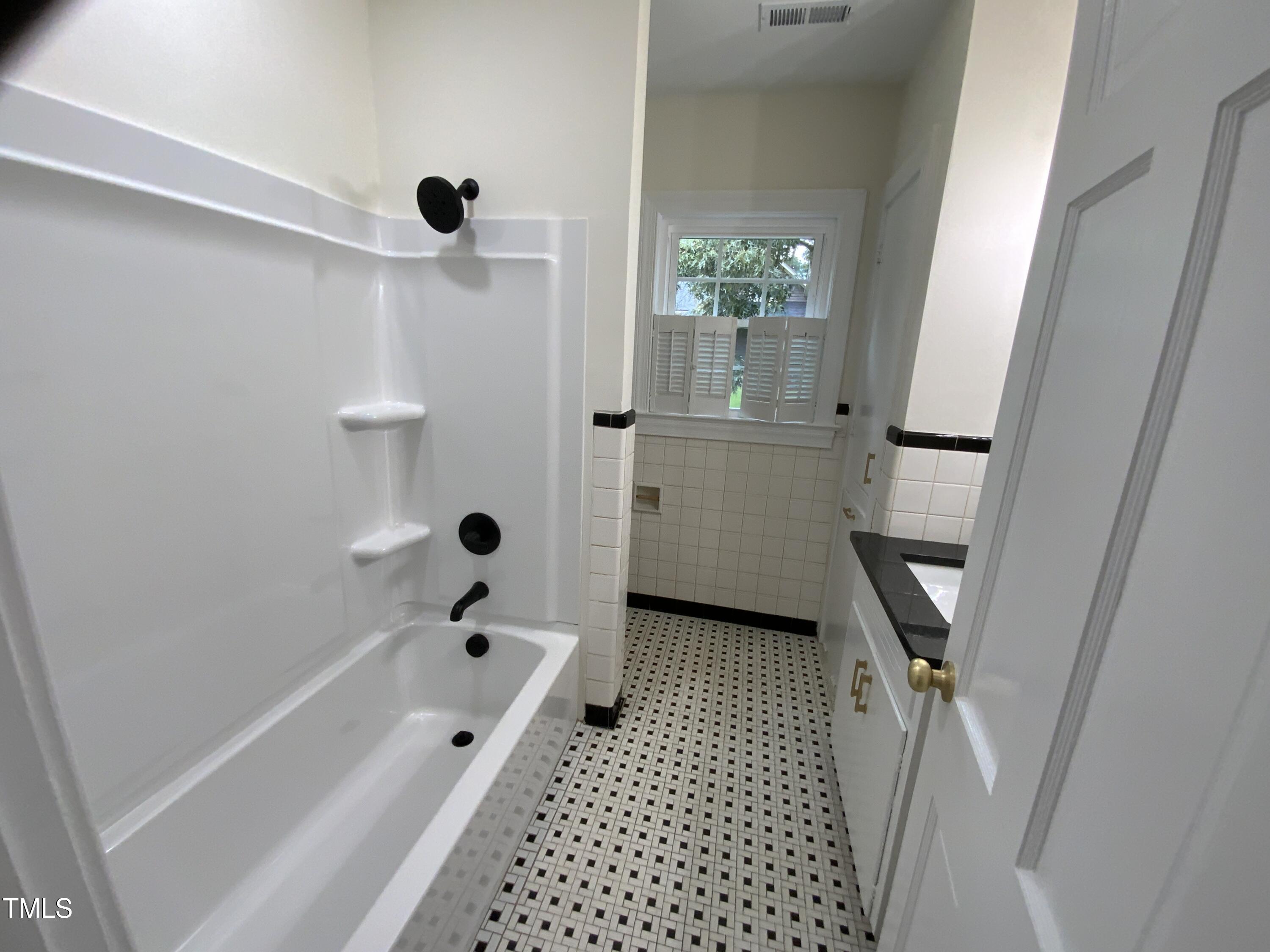 1101 West Divine Street Dunn, NC 28334 - Photo 22 of 36 a bathroom with a bathtub and shower