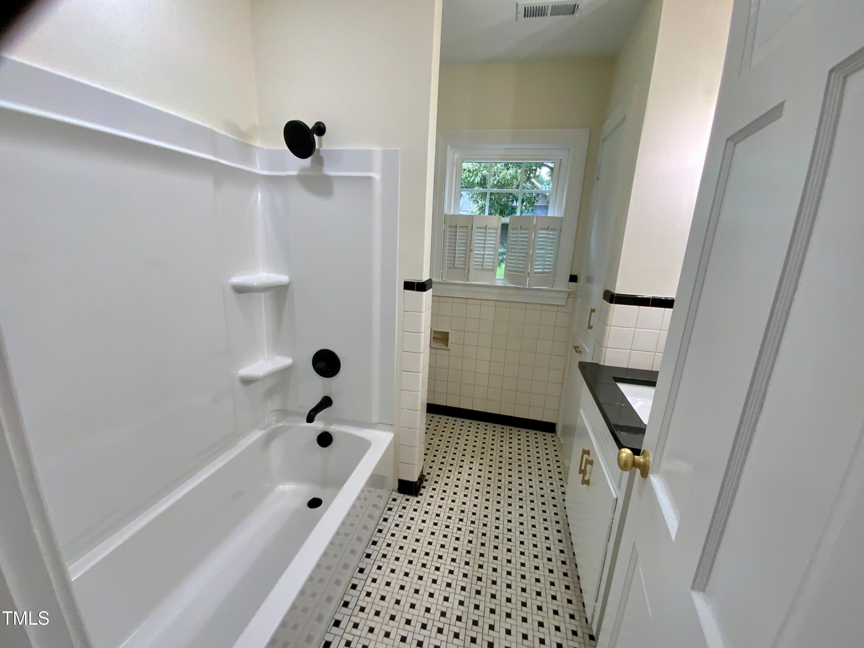 1101 West Divine Street Dunn, NC 28334 - Photo 25 of 36 a bathroom with a bathtub and shower