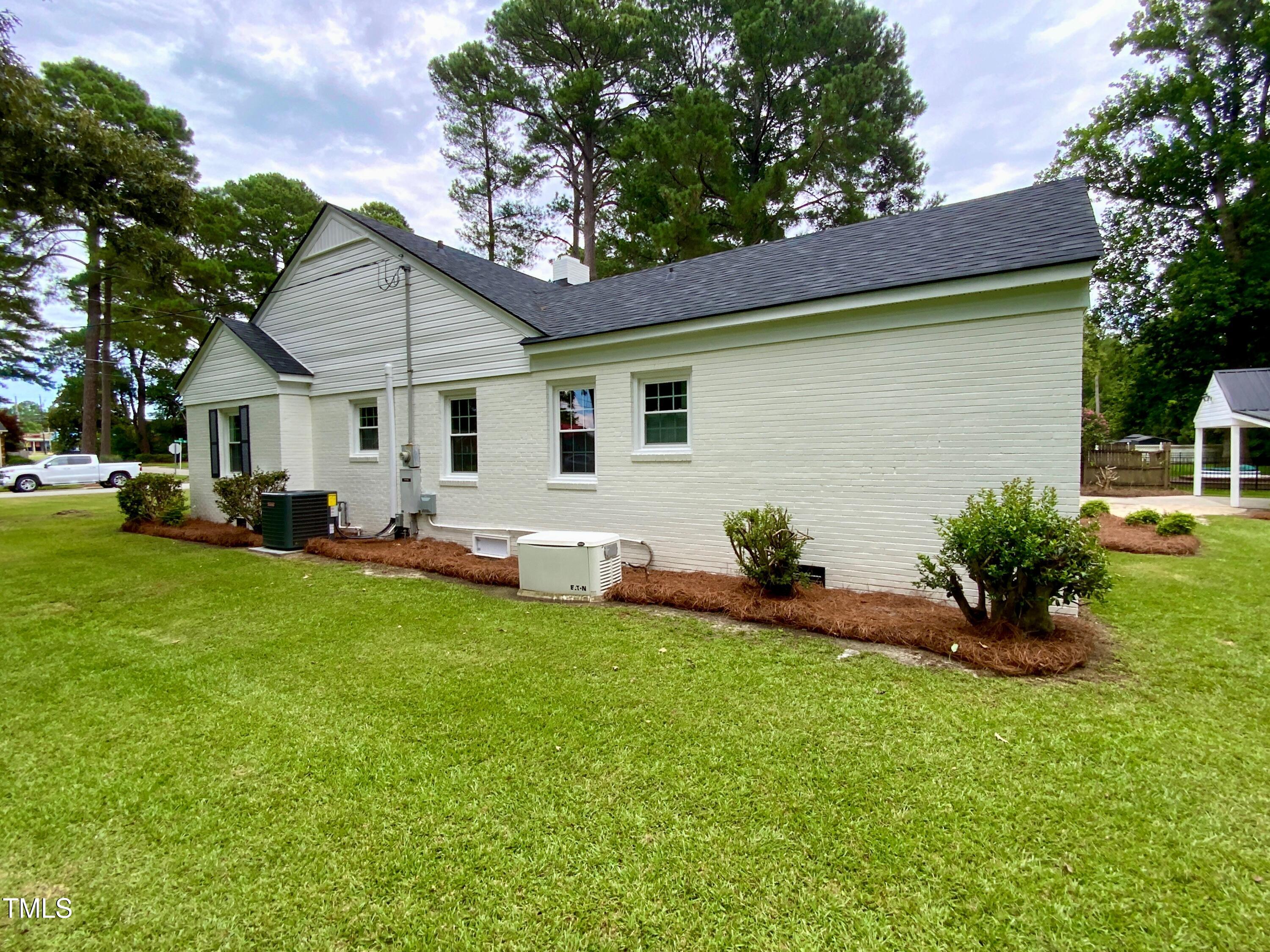 1101 West Divine Street Dunn, NC 28334 - Photo 32 of 36 a front view of house with yard and green space