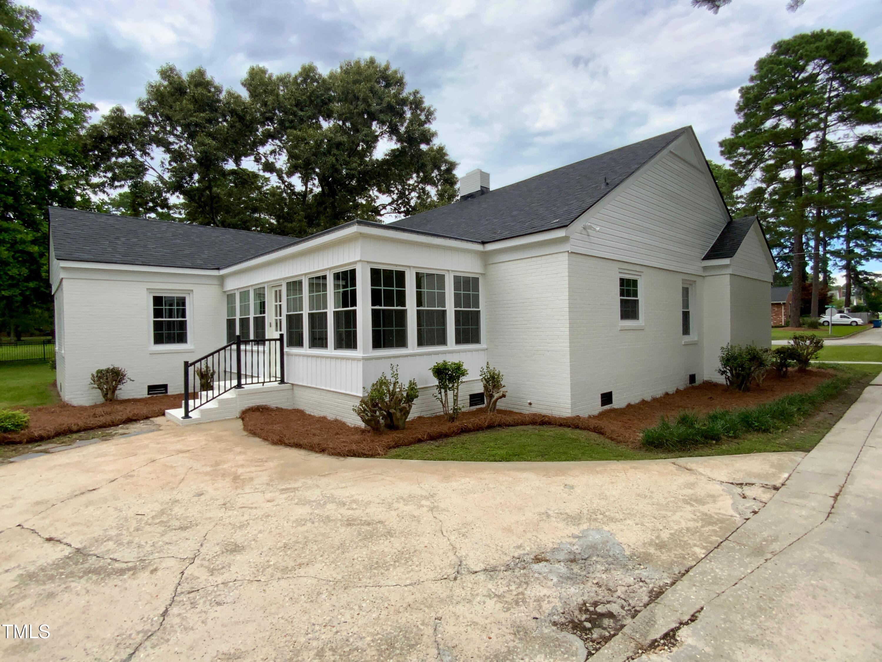 1101 West Divine Street Dunn, NC 28334 - Photo 35 of 36 a front view of a house with a yard and garage