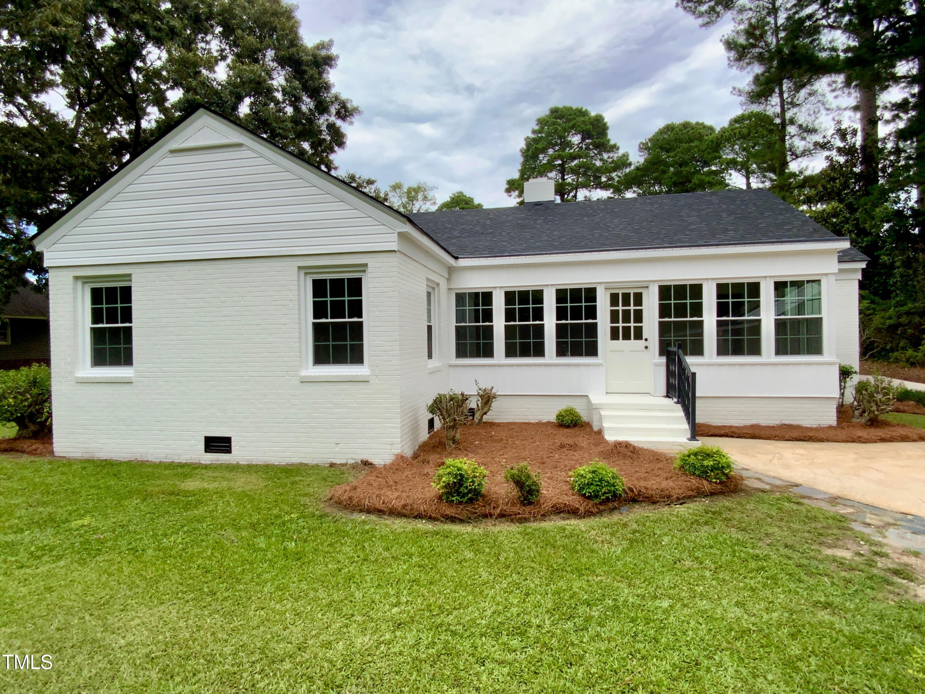 1101 West Divine Street Dunn, NC 28334 - Photo 36 of 36 a front view of a house with a yard