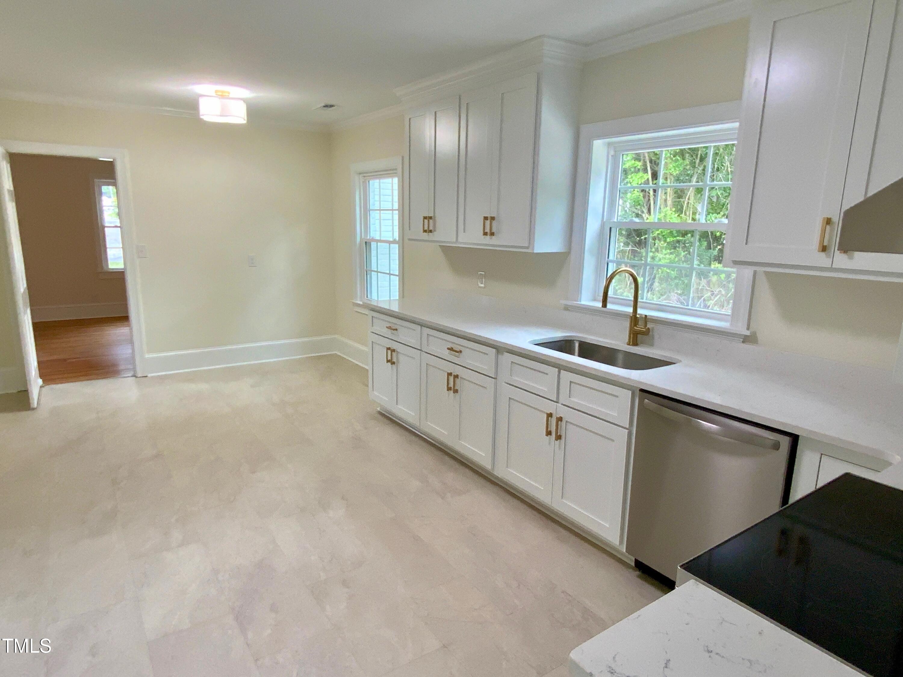 1101 West Divine Street Dunn, NC 28334 - Photo 5 of 36 a kitchen with a sink cabinets and window
