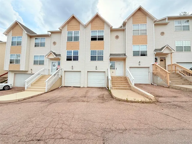 a view of a house with wooden fence