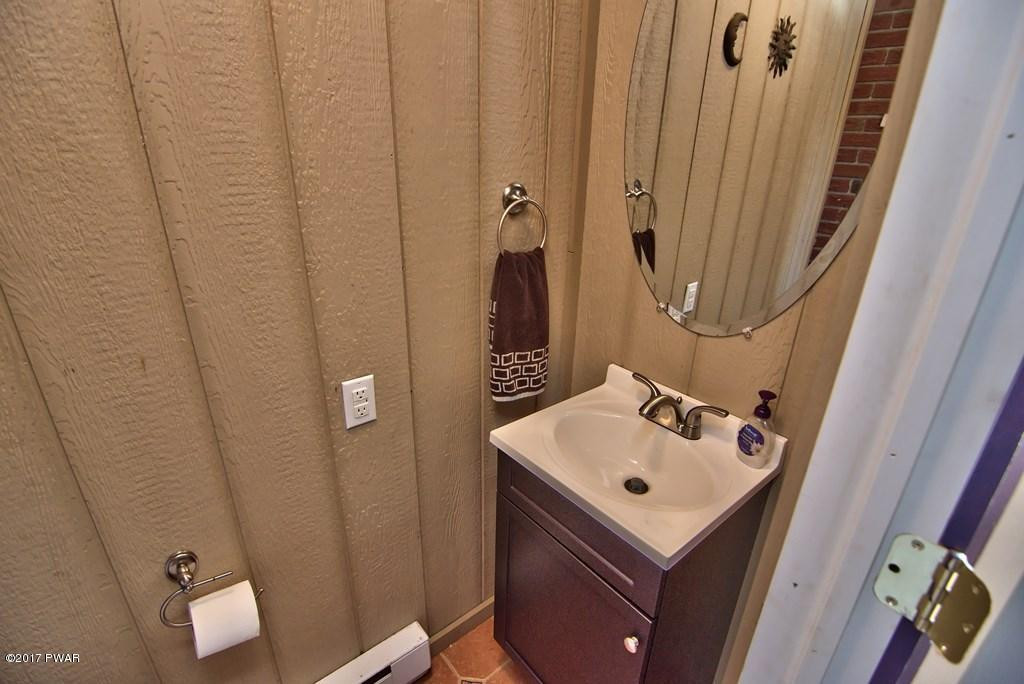 1058 Rosengrant Road Lake Ariel, PA 18436 - Photo 13 of 47 a bathroom with a sink a mirror and shower curtain