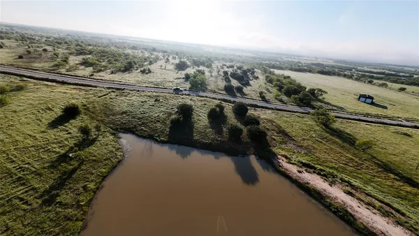 an aerial view of a house with a lake view