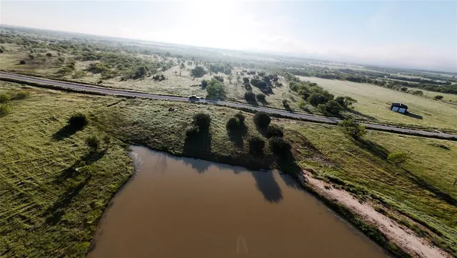 an aerial view of a house with a lake view