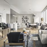 a living room with furniture a wooden floor and a large window