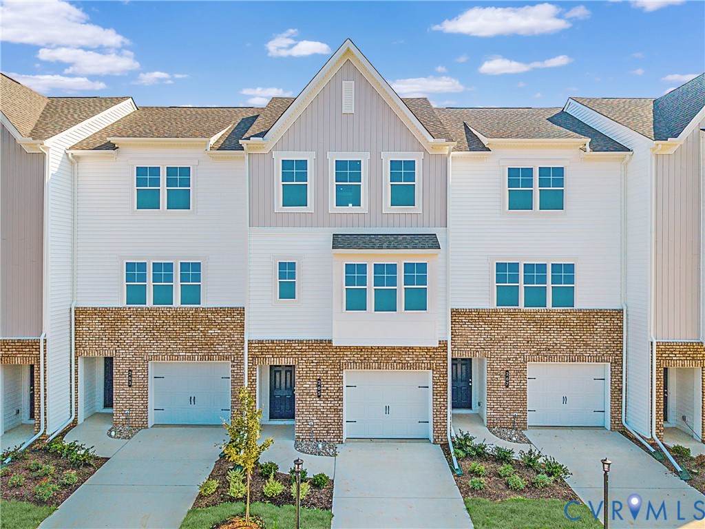 284 Greenpark Road Sandston, VA 23150 - Photo 2 of 26 a front view of a house with a yard and outdoor seating