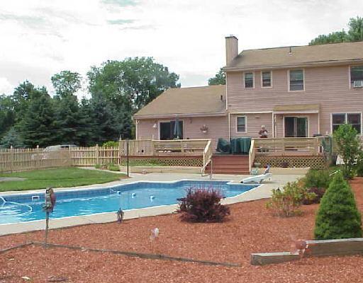 a view of a house with backyard and swimming pool