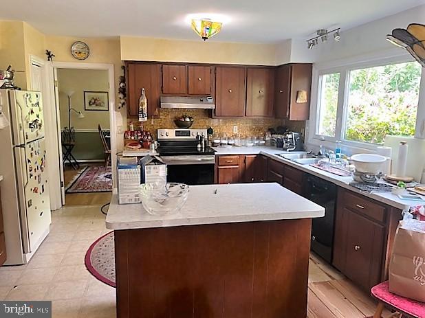51 Moore Lane Falling Waters, WV 25419 - Photo 15 of 47 a kitchen with stainless steel appliances a sink a stove a refrigerator cabinets and a dining table