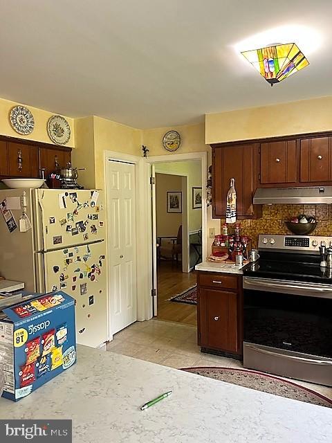 51 Moore Lane Falling Waters, WV 25419 - Photo 16 of 47 a kitchen with stainless steel appliances kitchen island granite countertop a refrigerator and a stove top oven