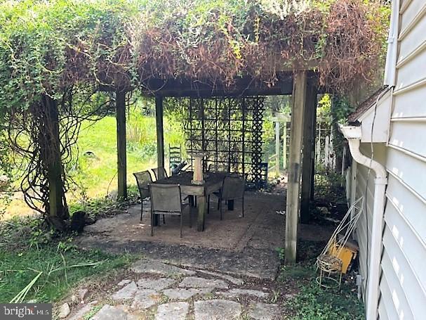 51 Moore Lane Falling Waters, WV 25419 - Photo 46 of 47 a view of a patio with table and chairs potted plants and large tree