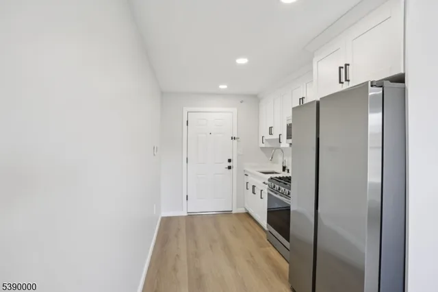 a kitchen with a refrigerator and a sink