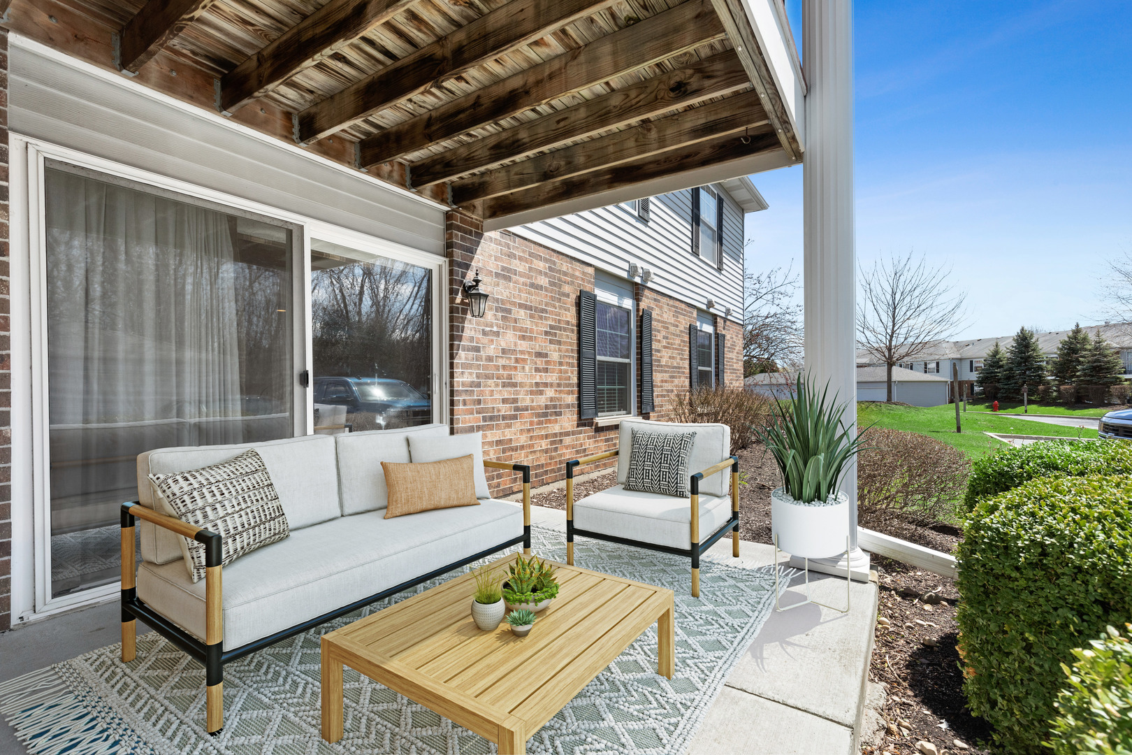 935 Golf Course Road, Unit 4 Crystal Lake, IL 60014 - Photo 3 of 17 a view of a patio with couches and a table and chairs with garden view