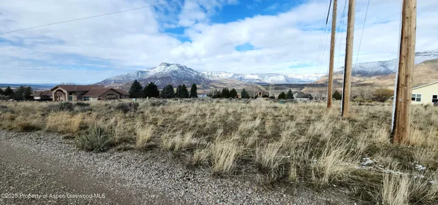 a view of a dry yard with mountains