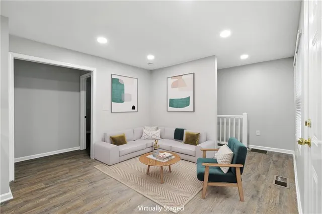 a living room with furniture and a wooden floor