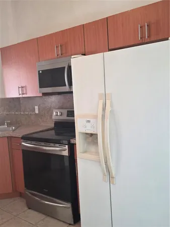 a kitchen with a stove and a microwave