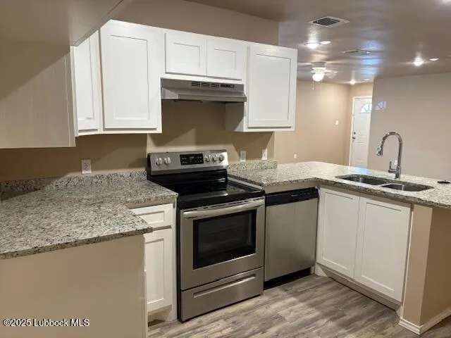 a view of a room with wooden floor