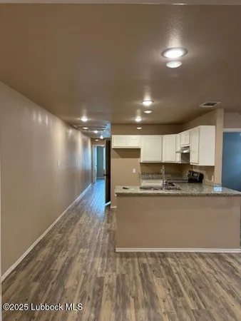 a view of hallway with wooden floor