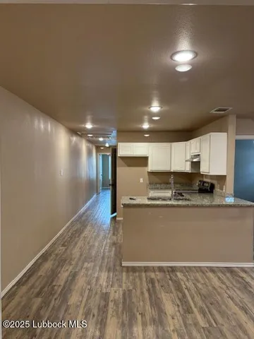a view of hallway with wooden floor