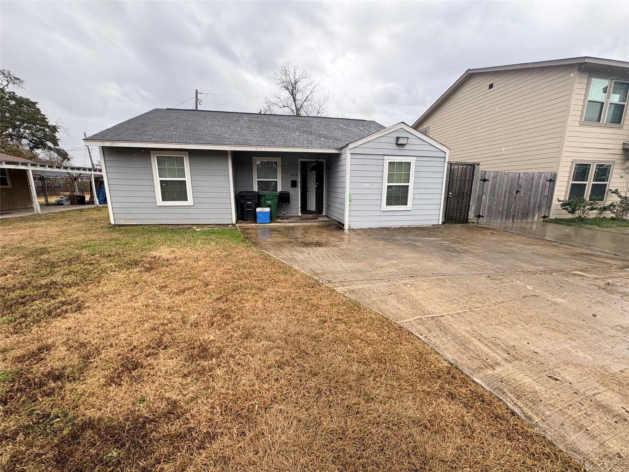 a front view of a house with a garden and yard