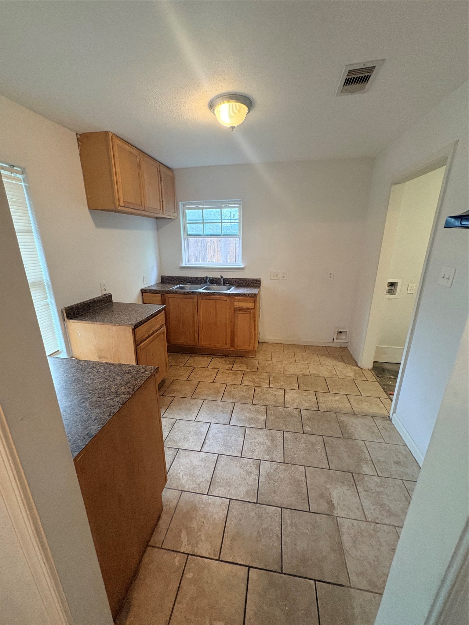 5510 Chennault Road Houston, TX 77033 - Photo 4 of 10 a kitchen with granite countertop a sink a stove a counter top space and cabinets