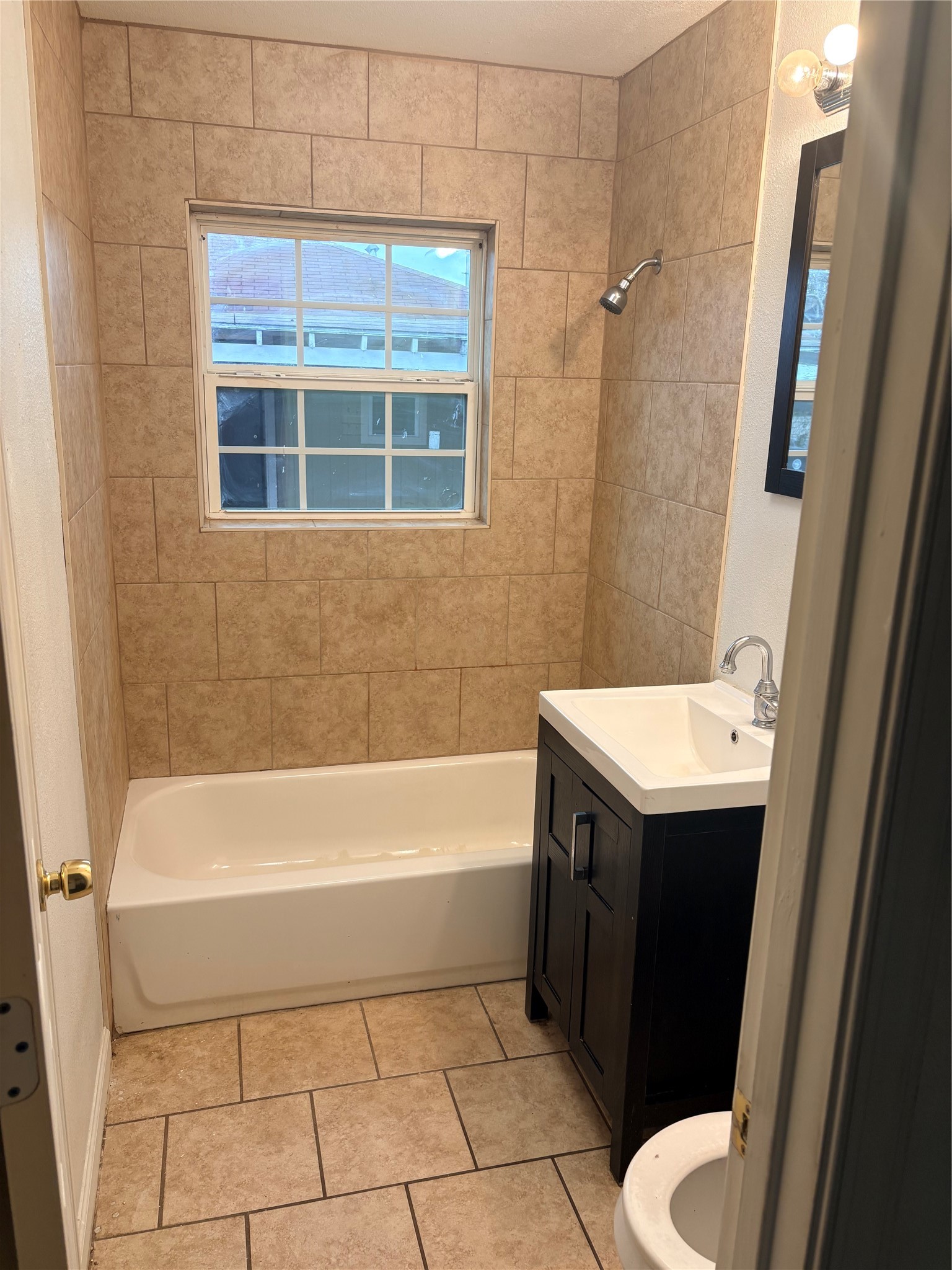 5510 Chennault Road Houston, TX 77033 - Photo 9 of 10 a bathroom with a bathtub sink and toilet