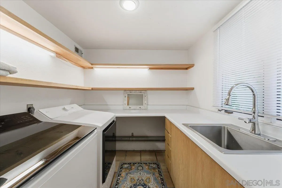 7030 Elfin Oaks Road Escondido, CA 92029 - Photo 15 of 36 a kitchen with a sink a stove and cabinets