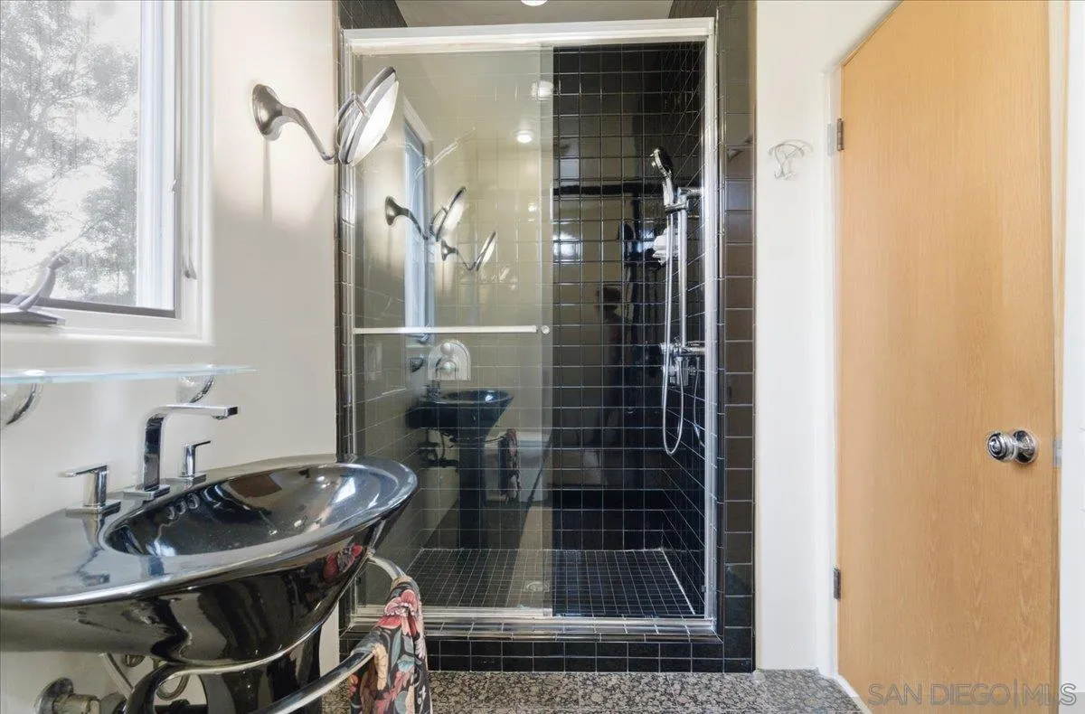 7030 Elfin Oaks Road Escondido, CA 92029 - Photo 16 of 36 a bathroom with a sink and a mirror