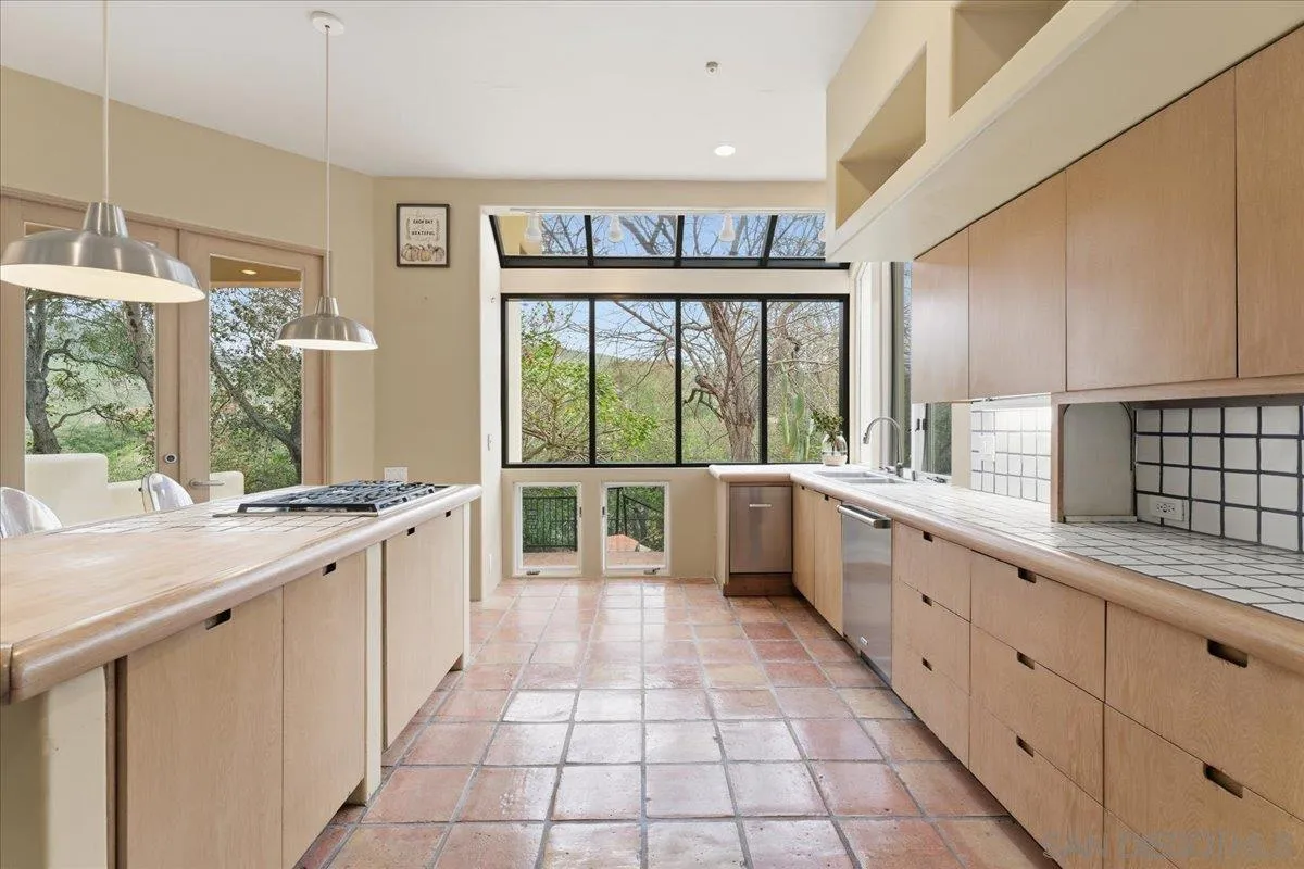 7030 Elfin Oaks Road Escondido, CA 92029 - Photo 23 of 36 a large white kitchen with a large window