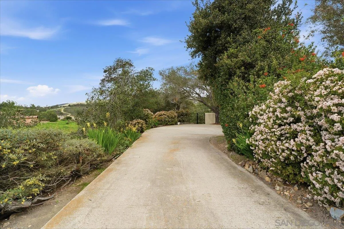 7030 Elfin Oaks Road Escondido, CA 92029 - Photo 25 of 36 a view of a pathway both side of grassy field with trees
