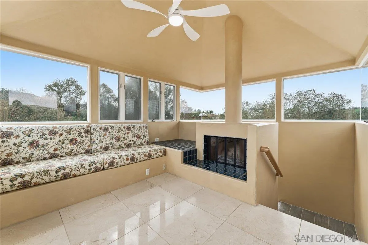 7030 Elfin Oaks Road Escondido, CA 92029 - Photo 26 of 36 a large white bed sitting in a living room next to a window