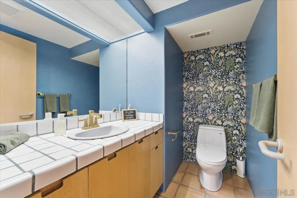 7030 Elfin Oaks Road Escondido, CA 92029 - Photo 30 of 36 a bathroom with a sink toilet and mirror