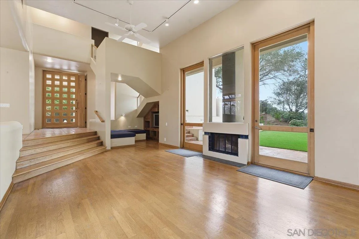 7030 Elfin Oaks Road Escondido, CA 92029 - Photo 5 of 36 a living room with fireplace furniture and a floor to ceiling window