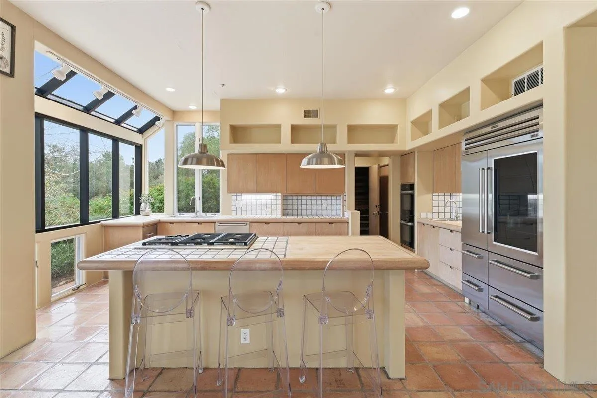 7030 Elfin Oaks Road Escondido, CA 92029 - Photo 9 of 36 a kitchen with stainless steel appliances granite countertop a stove and a refrigerator