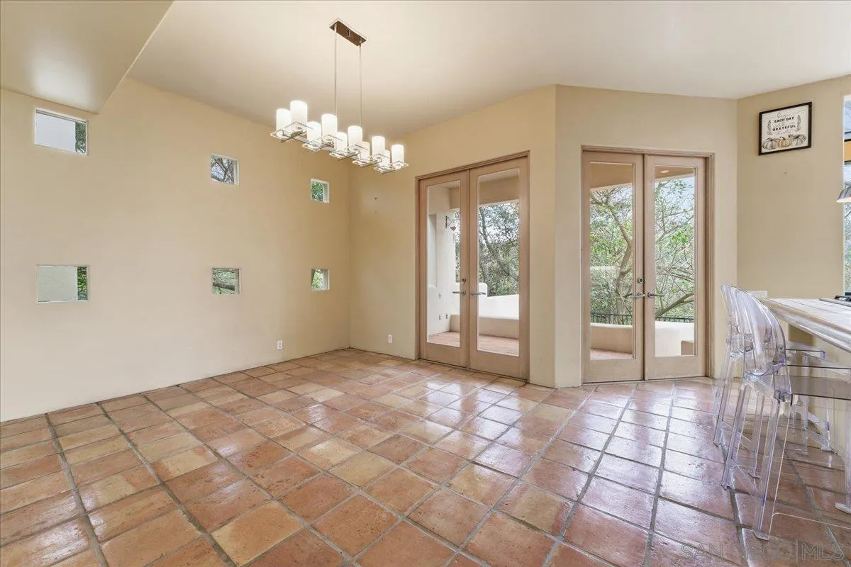 7030 Elfin Oaks Road Escondido, CA 92029 - Photo 10 of 36 a view of a livingroom with a chandelier fan and windows