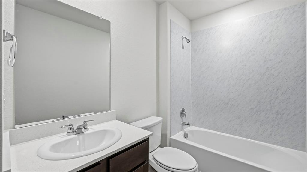 729 Lantana Lane Pilot Point, TX 76258 - Photo 13 of 19 a bathroom with a sink toilet and bathtub