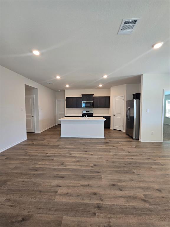 729 Lantana Lane Pilot Point, TX 76258 - Photo 2 of 19 a view of kitchen with refrigerator microwave and white cabinets