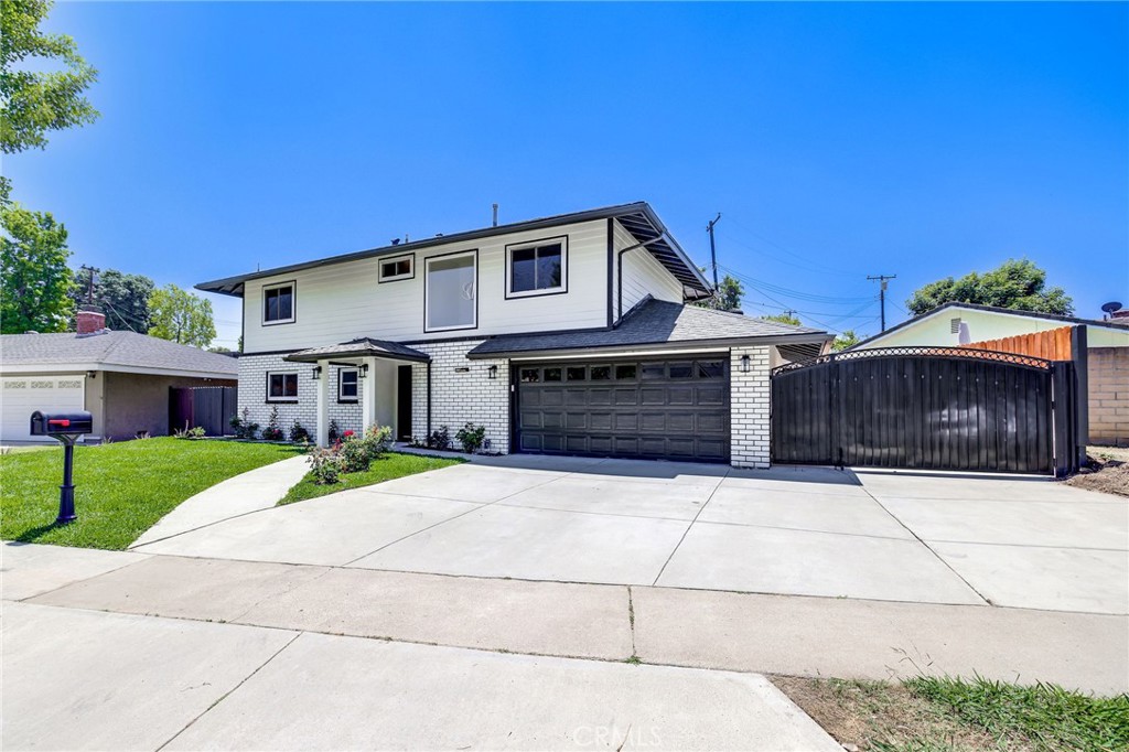 334 North Starfire Street Anaheim, CA 92807 - Photo 1 of 1 a front view of a house with a yard and garage