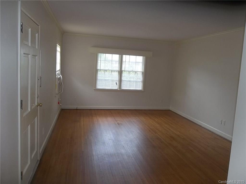 4227 Walker Road, Unit 4 Charlotte, NC 28211 - Photo 2 of 6 an empty room with wooden floor and windows