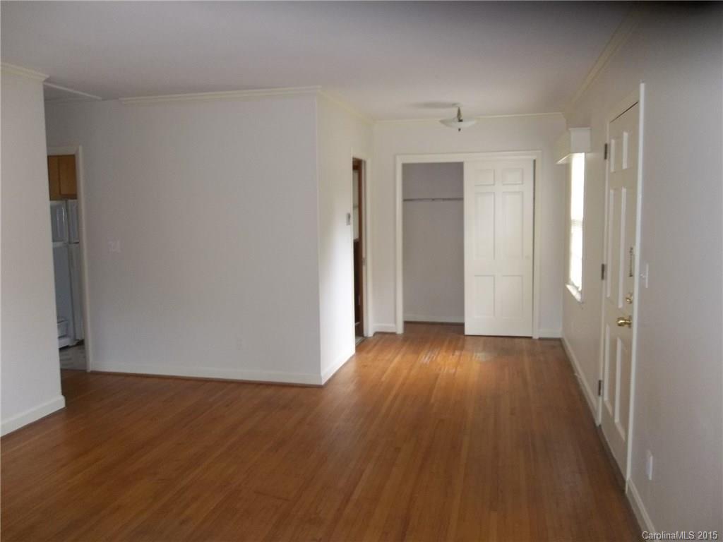 4227 Walker Road, Unit 4 Charlotte, NC 28211 - Photo 5 of 6 a view of an empty room with wooden floor and a window